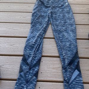 Black leggings with white and dark gray stripes.